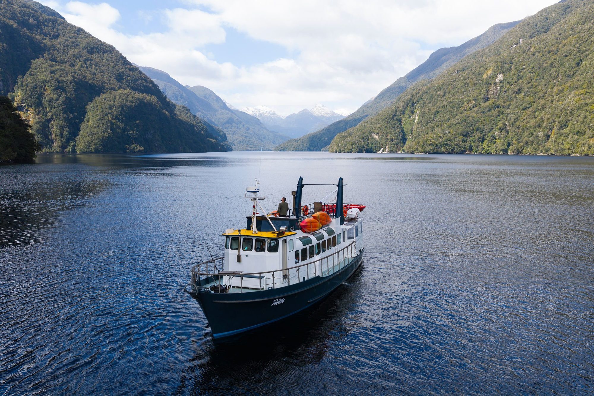 MV Tutoko from above in Doubtful Sound, with snow on the peaks beyond